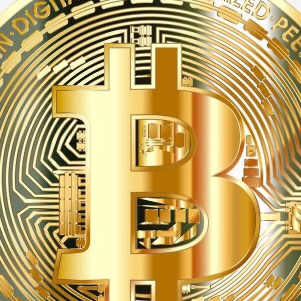 A physical Bitcoin coin, representing the BTC locked on the main chain behind a sidechain token