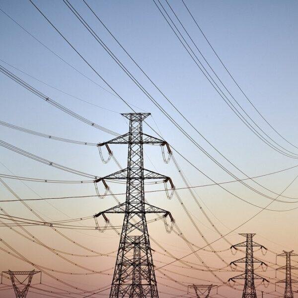 Power transmission towers, representing the grid access constraint behind the Crusoe valuation