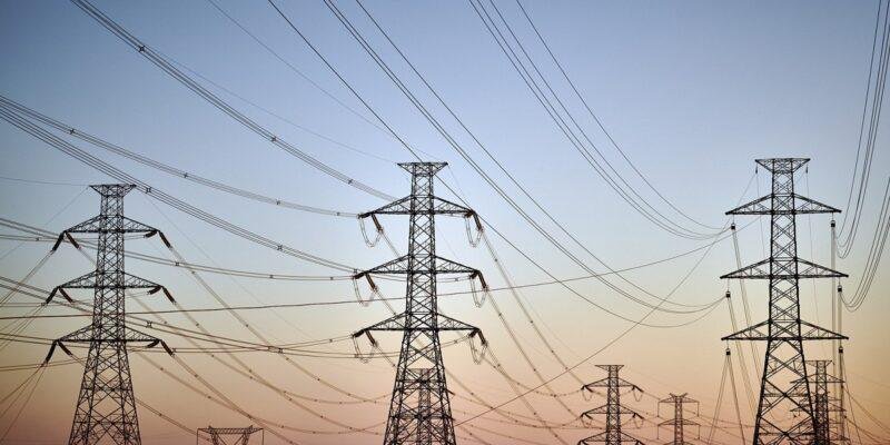 Power transmission towers, representing the grid access constraint behind the Crusoe valuation