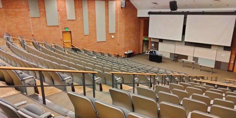 University lecture hall representing the OpenAI Navier-Stokes proof and the academic credit dispute